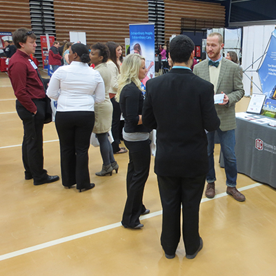 Students interacting with employers at career fair
